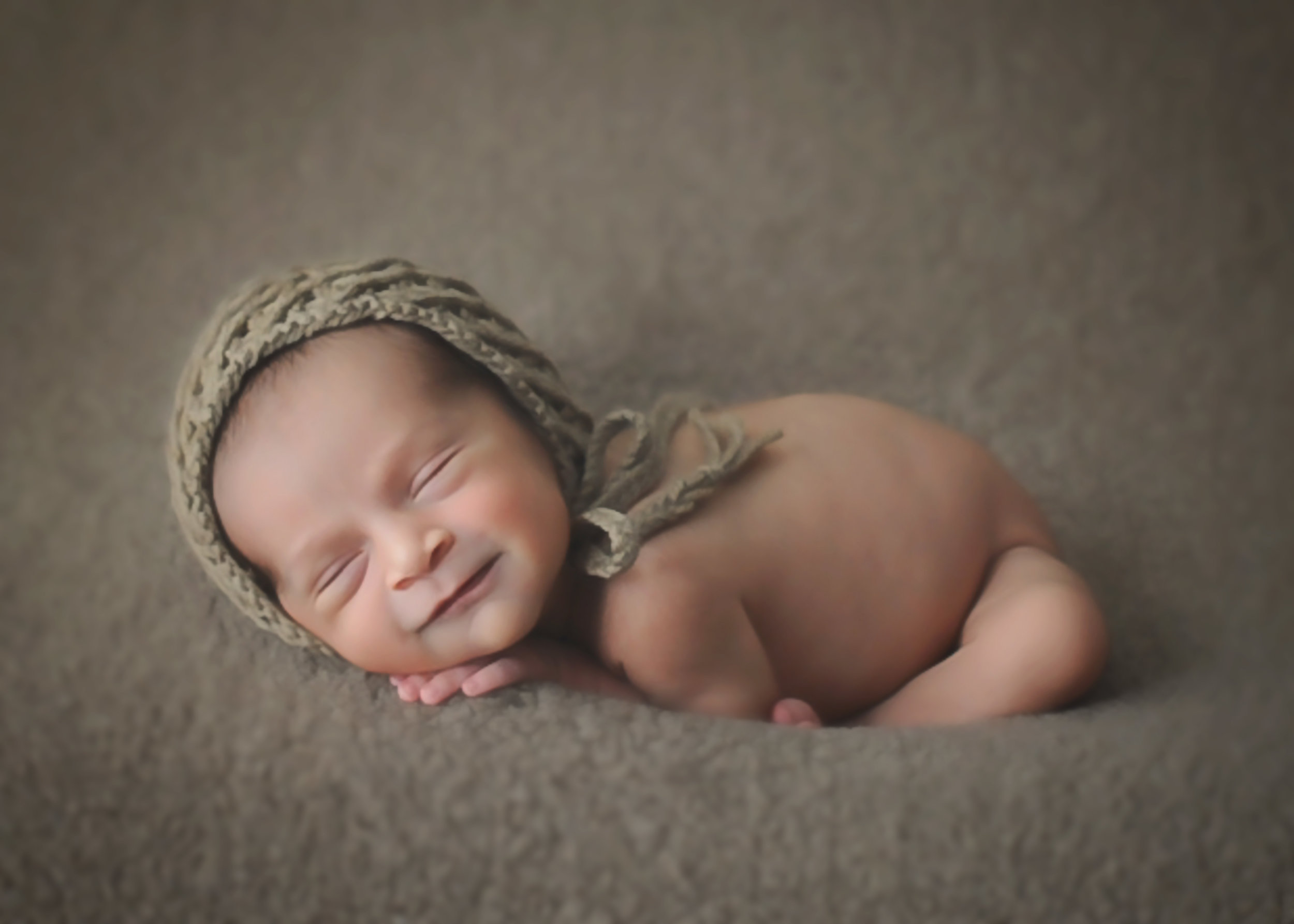 Newborn boy in tan hat.jpg