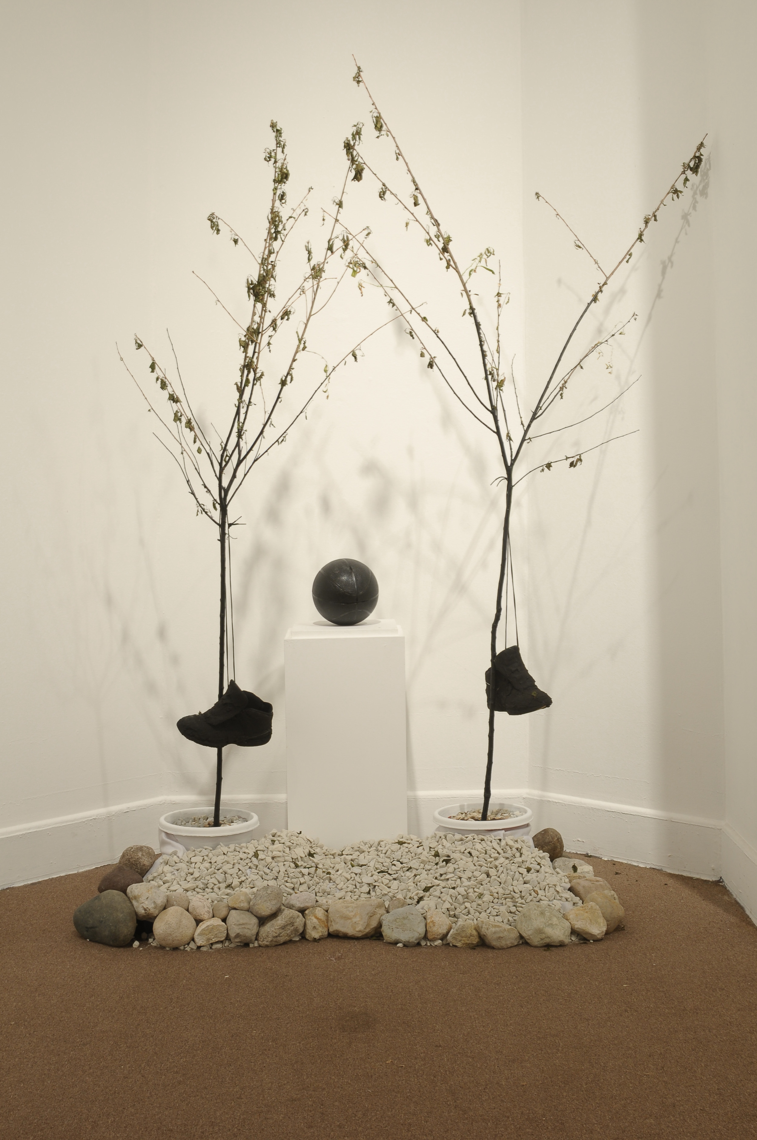  Throne to the Basketball Gods  stones, sneakers, wooden pedestal, basketball, cherry tree, spray paint  65"x 45"x 86"  2012 