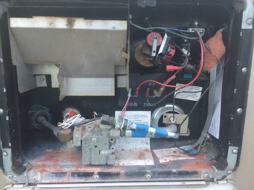 Before we knew what the hell was going on. Note the taped on piece. The missing plug (kind of hidden to the left, behind the white cords) And the hornet nest.....