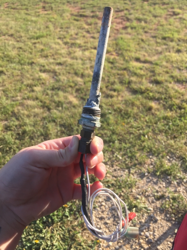 The piece that was taped to the front of the water heater. That ended up being the "plug" AND electric convertor. 