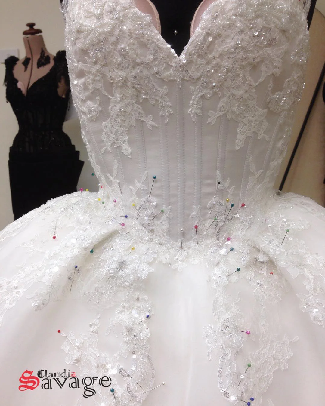 Pins, pins and more pins as the bodice lace is carefully hand stitched into place.
