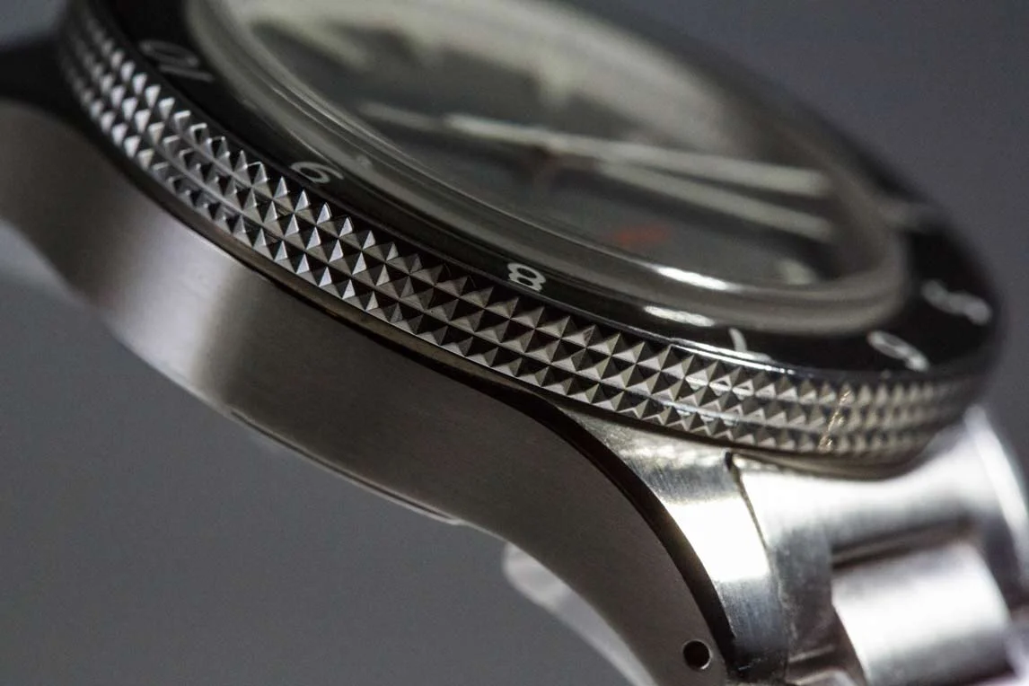 The knurled bezel grip is not visible when looking straight-on at the watch. The case has a slight bowl shape to it, which helps take some heft away from the watch.