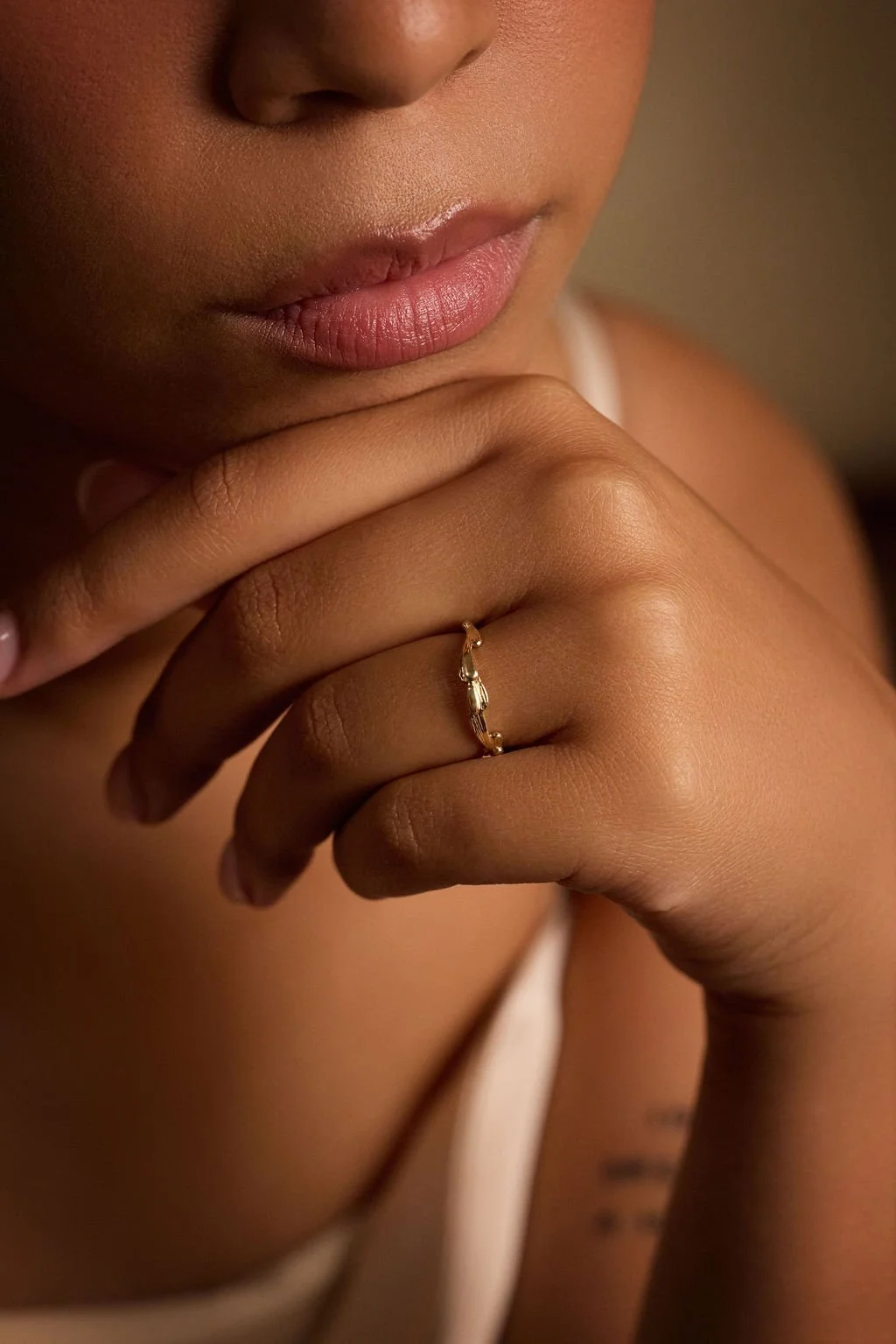 A model wears the textured gold Spray Ring.