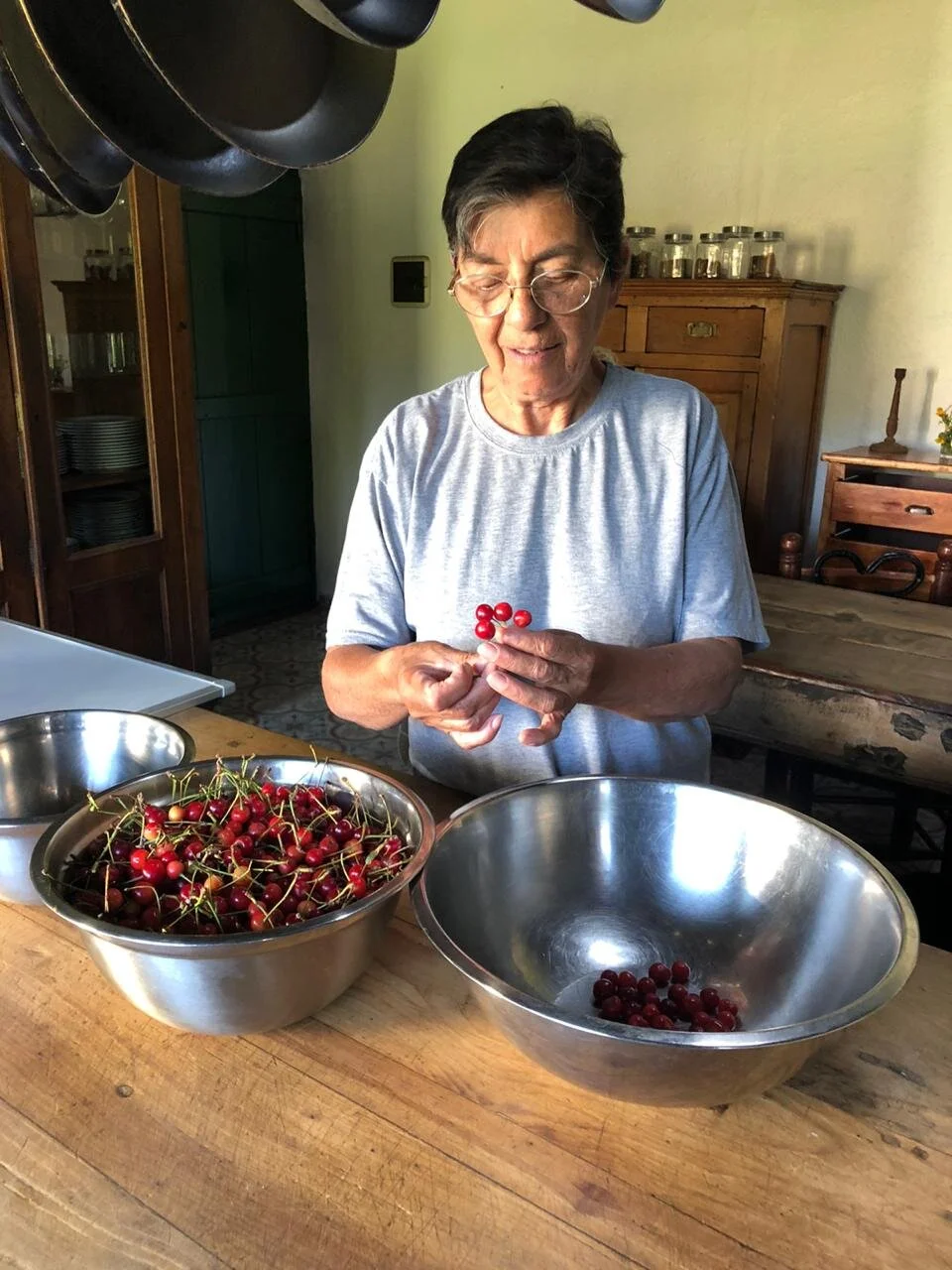 Maga beginning the task of de-stoning the cherries.