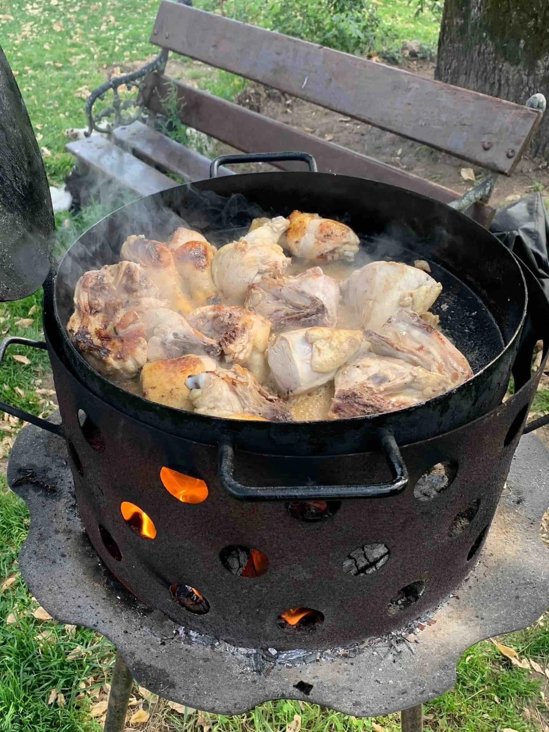 Traditional Argentine pollo al disco with sautéed chicken, red and green peppers and fresh herbs