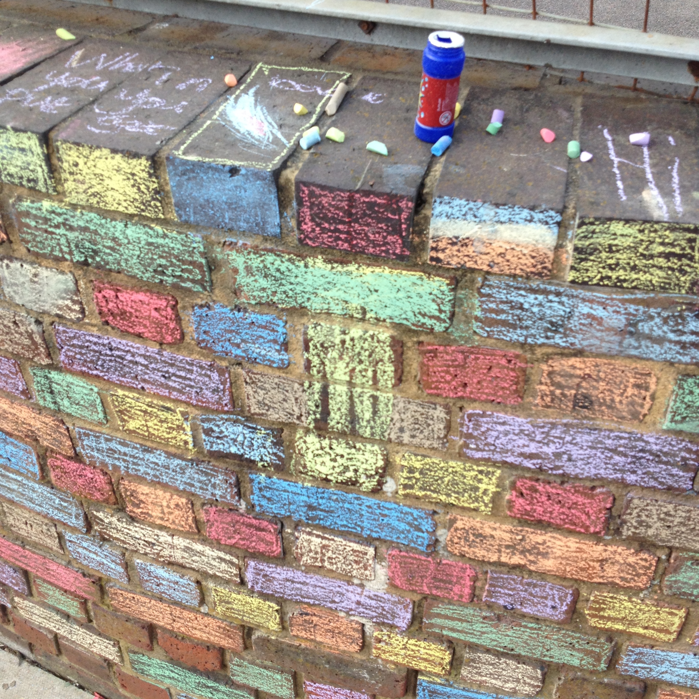 chalking the football cage wall to brighten up the neighbourhood