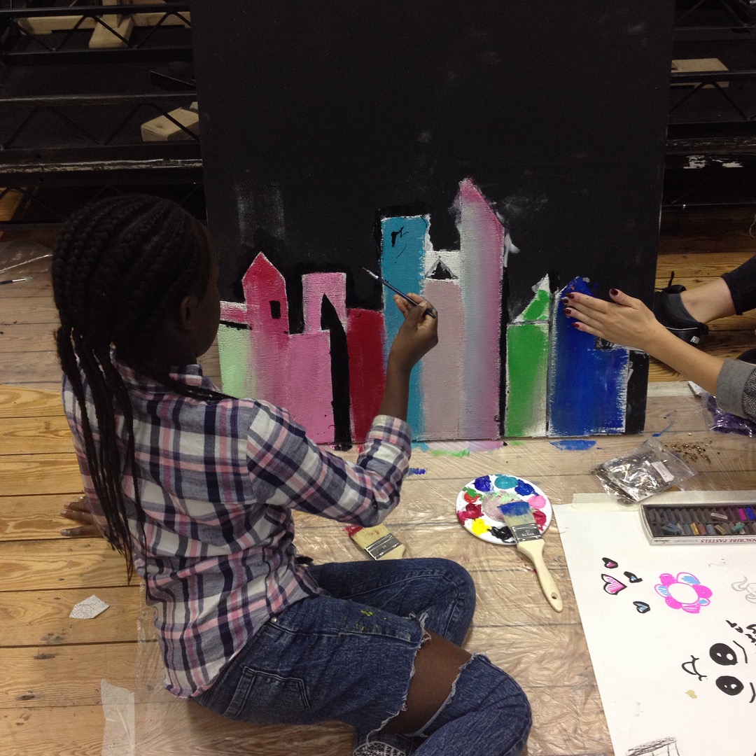 young people making a collaborative canvas during half term at an XLP creative workshop
