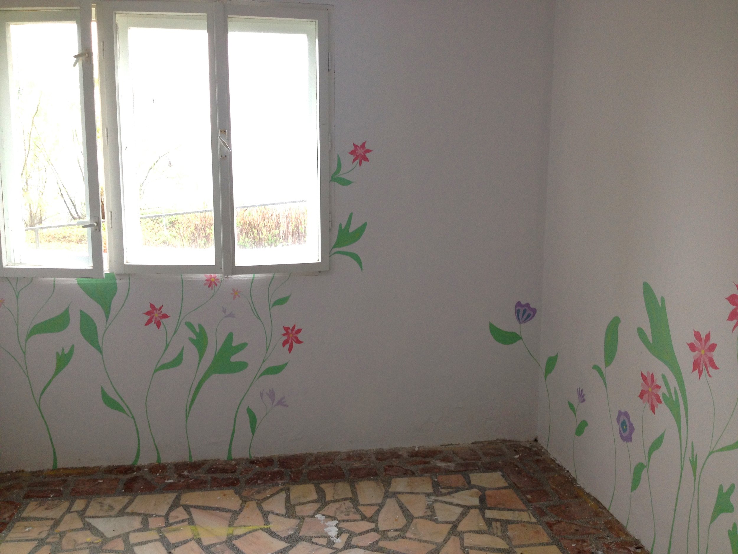 painting a garden mural in the prayer room at Casa Harilui, a retreat home for disabled children in Romania