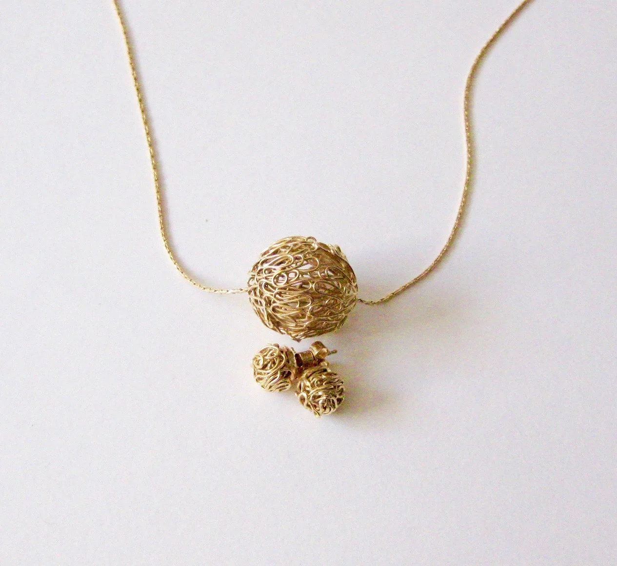 ‘Woven Sphere Pendant and Earrings’ 2018, Gold plated Sterling Silver