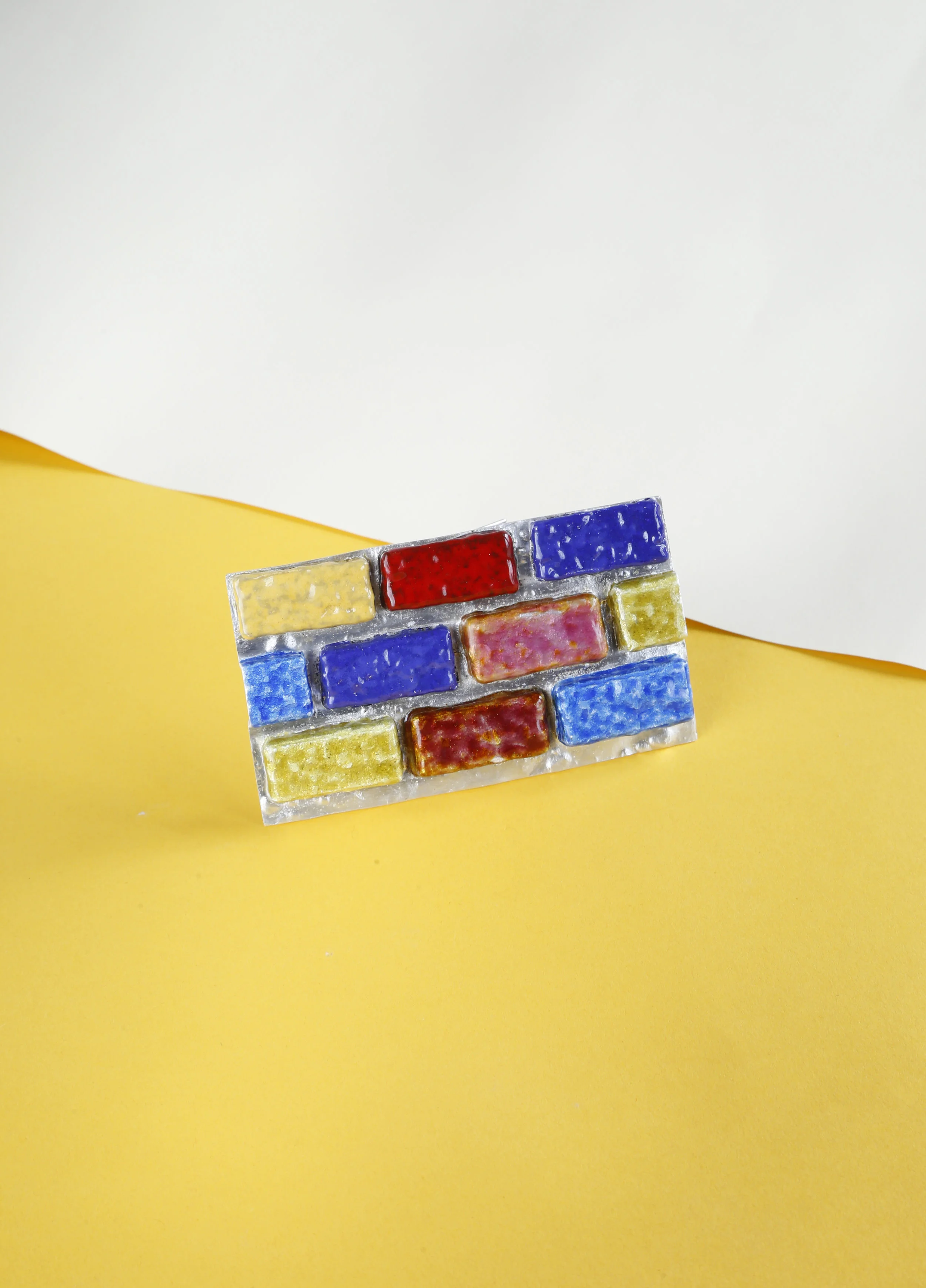 The Brick brooch, 2016; fine silver, steel wire, vitreous enamel.