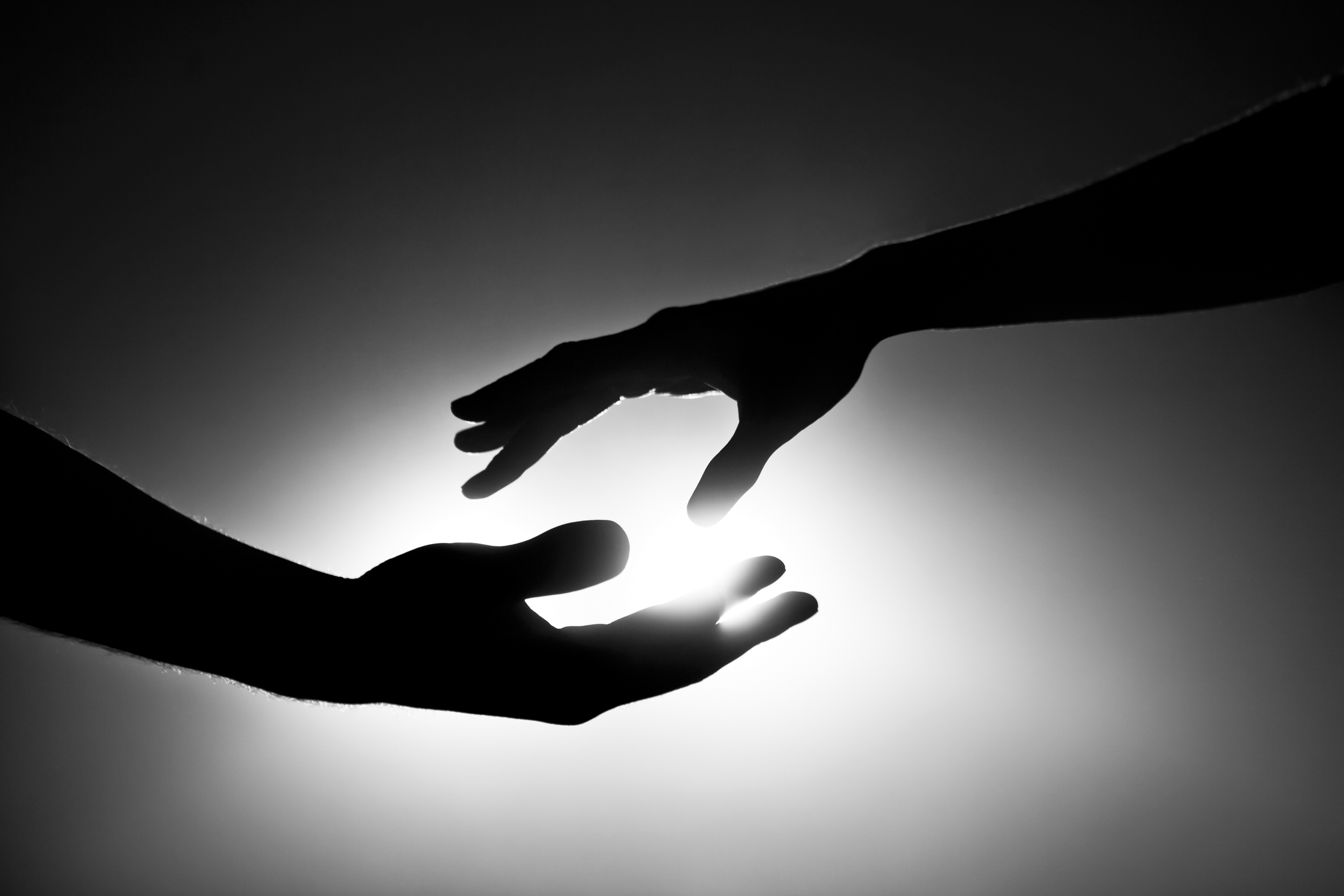 Black-and-white-image-of-two-hands-reaching-out-000022949856_Large.jpg