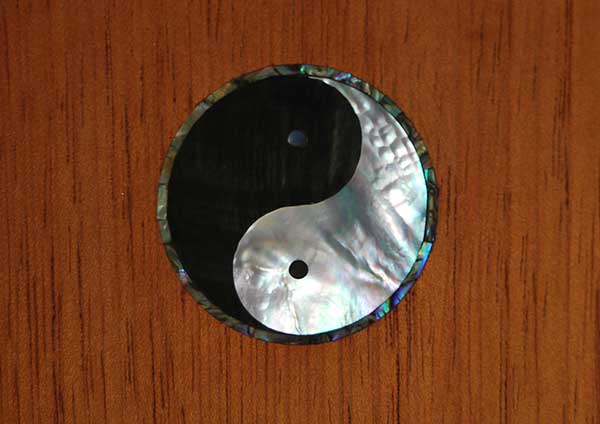 Black and white mother of pearl and abalone rosette in a Spanish cedar door