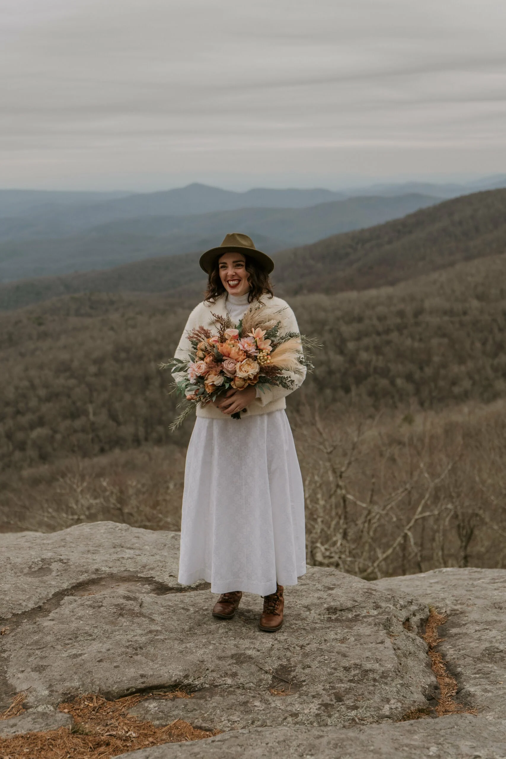 winter-elopement-smiling-woman-with-flowers-scaled.jpg