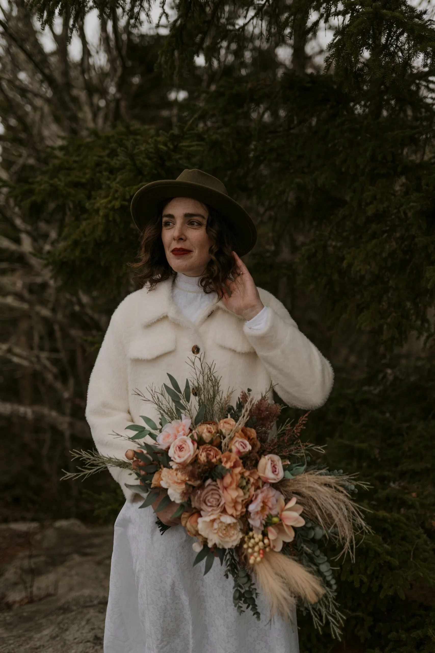 winter-elopement-woman-with-hat-and-bouquet-scaled.jpg