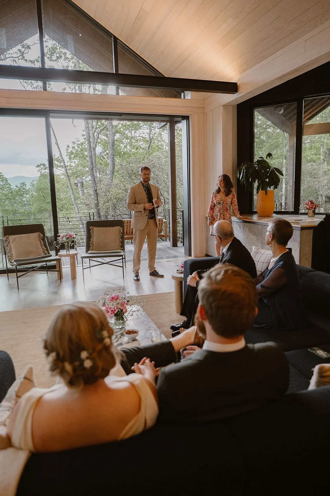 Wedding reception toasts take place in a cabin