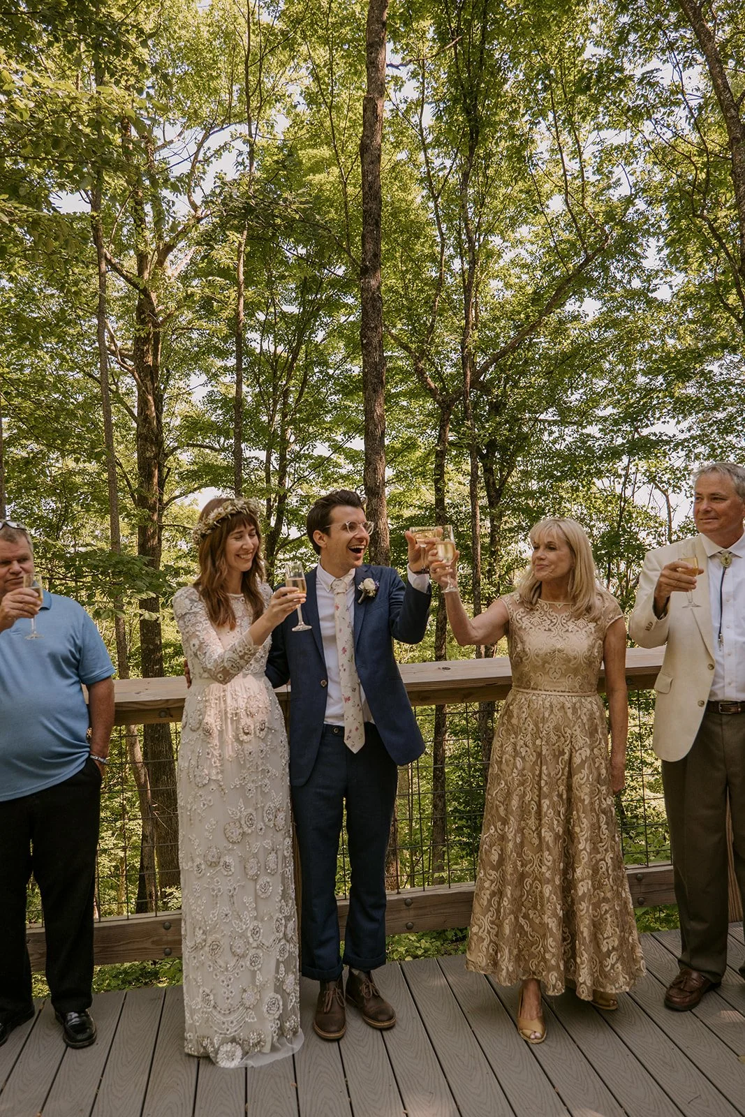 Post-elopement party scene on a woodsy cabin deck