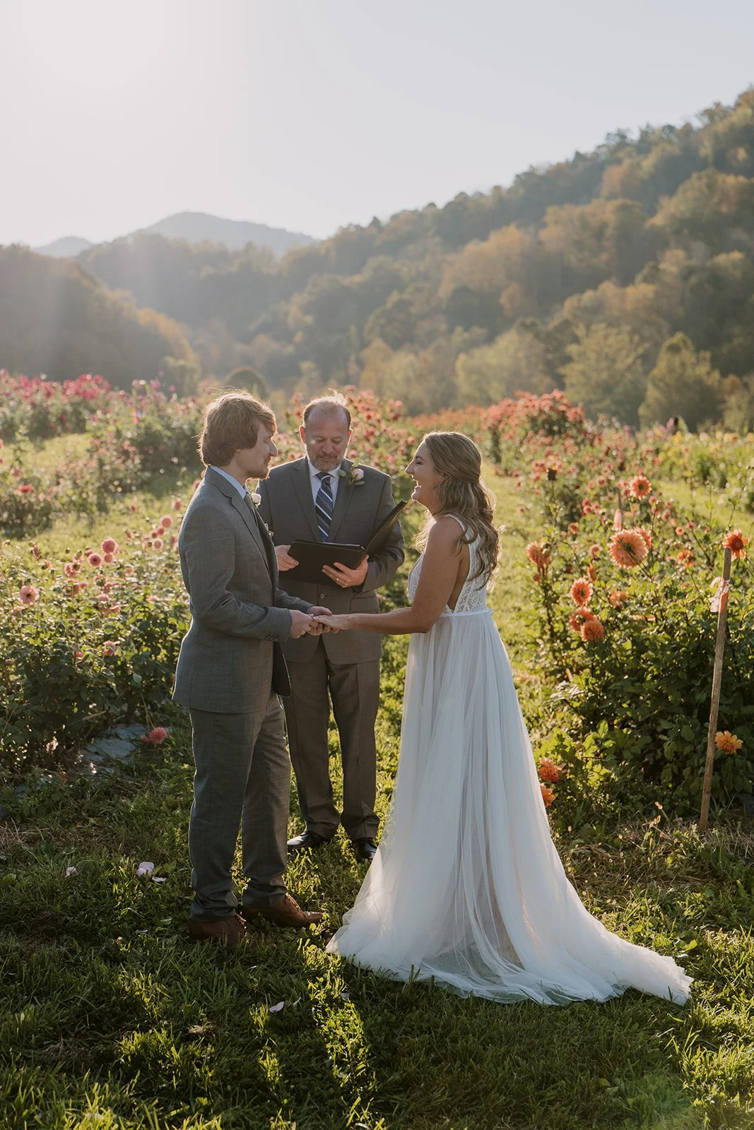 Sunset lights a bride and groom eloping in a flower field
