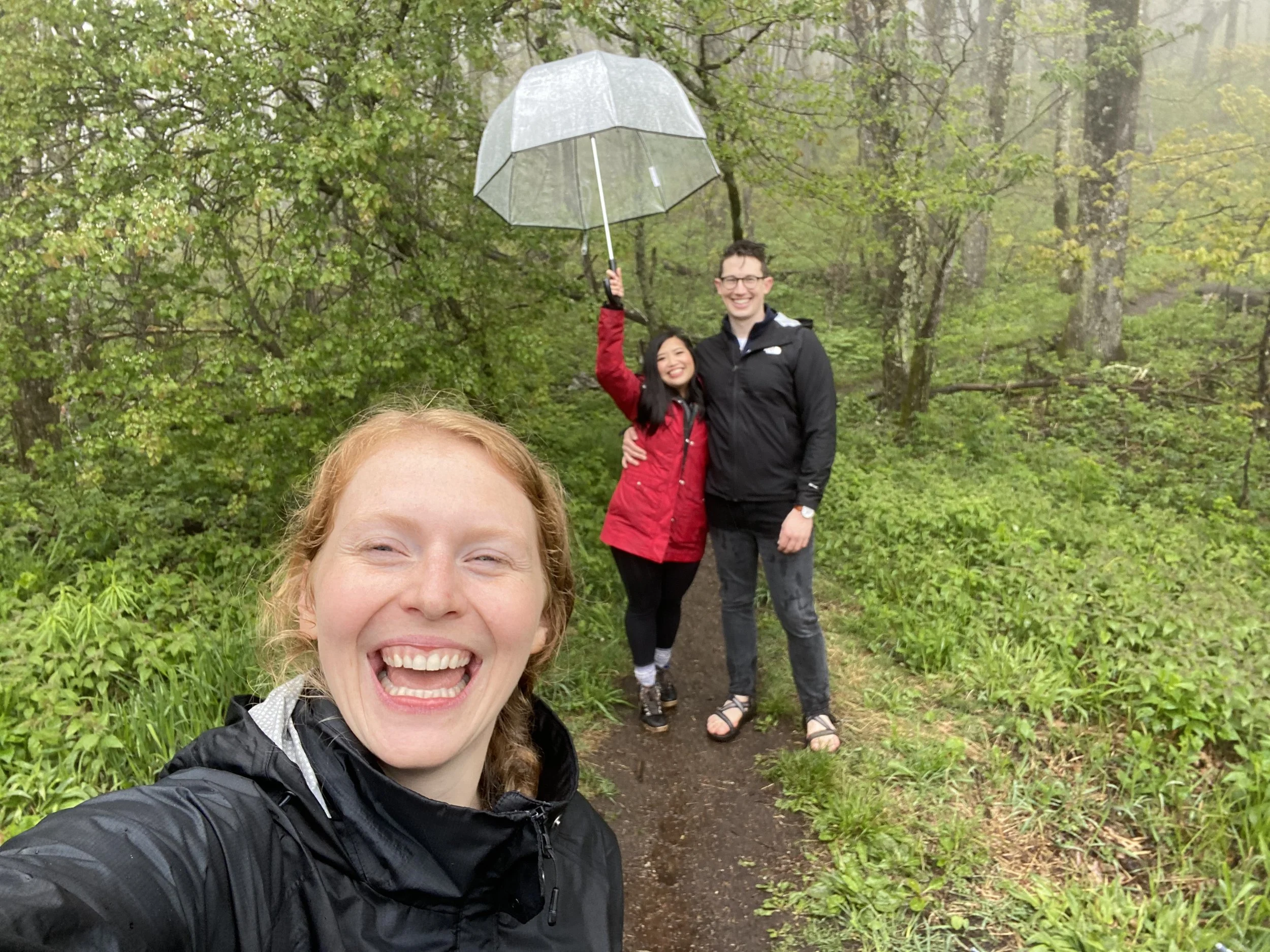Hikers take a selfie on a misty mountain trail