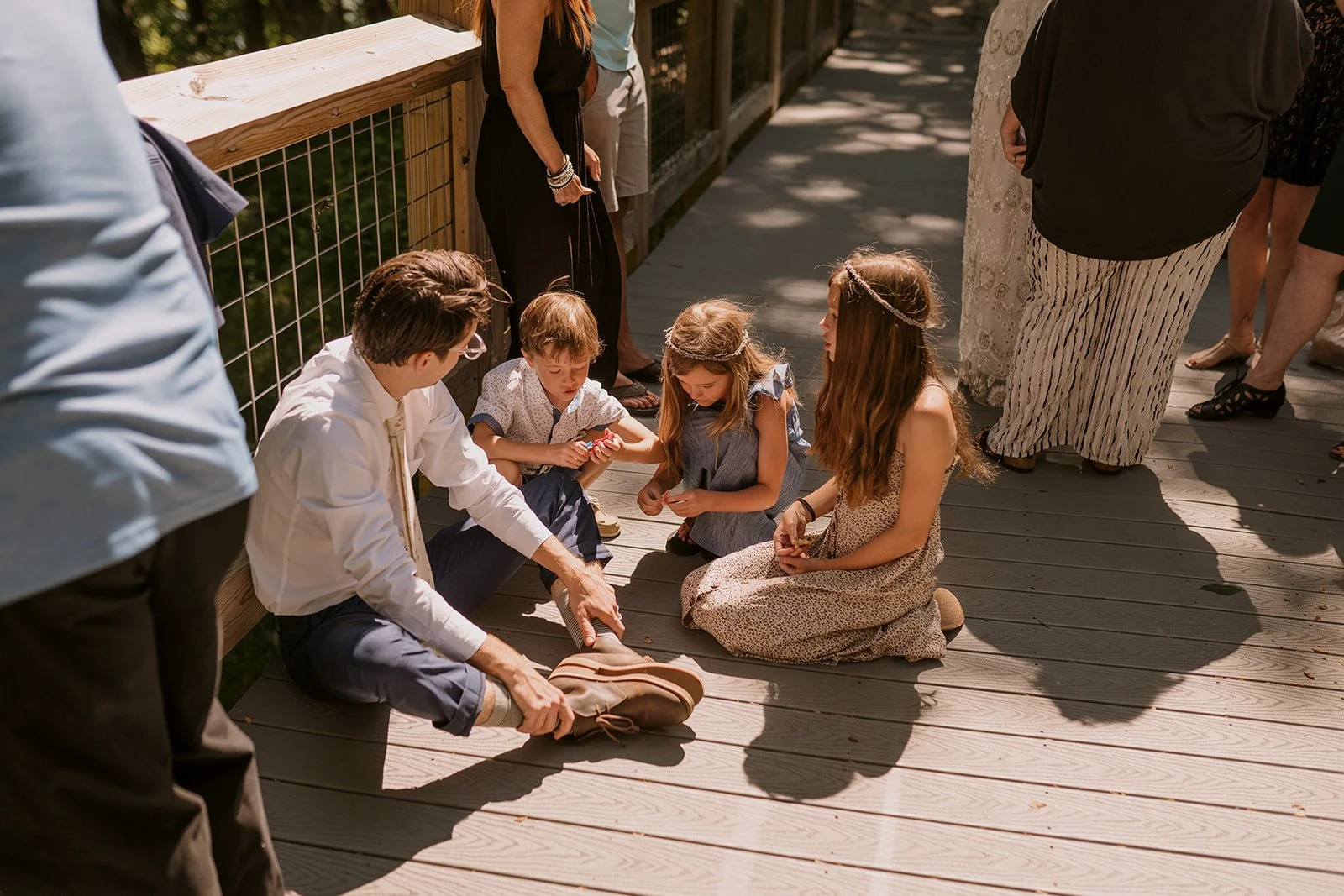 Backyard elopement reception scene featuring children playing on back deck
