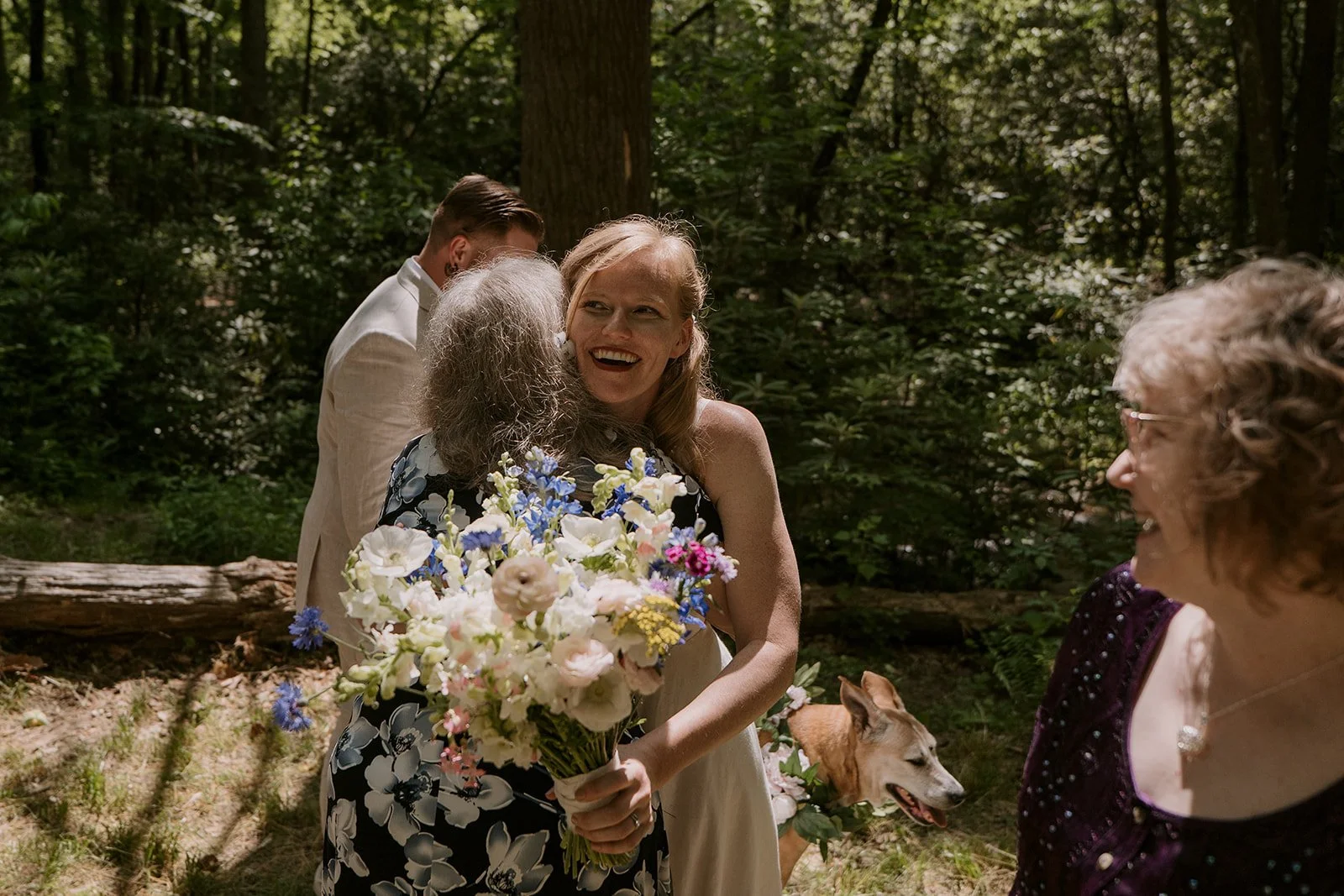 A bride hugs her mom in a outdoor elopement reception
