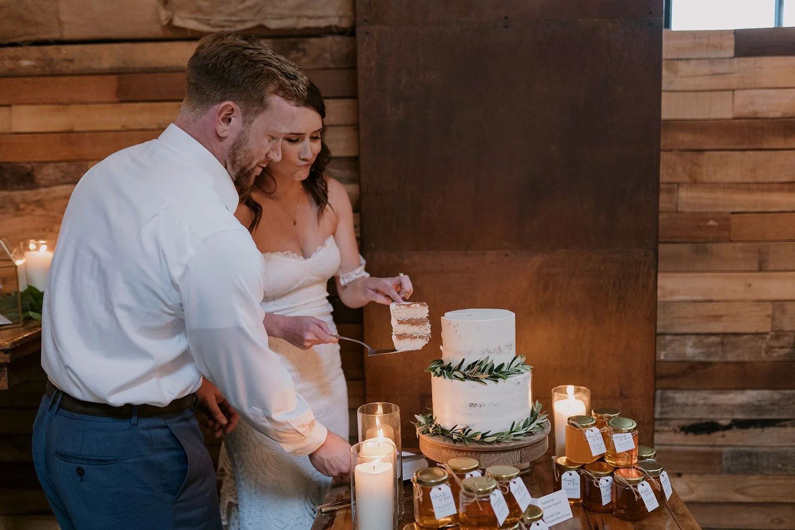 A bride and groom cut their wedding cake