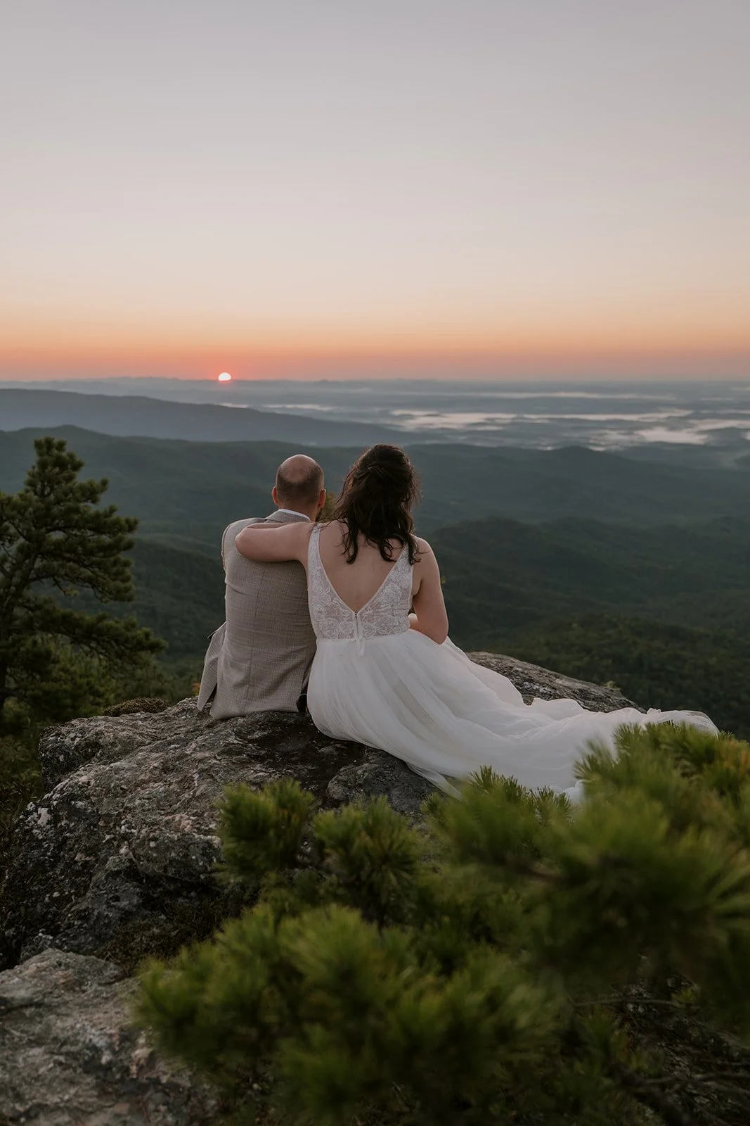A bride and groom take in the sunset in the Blue Ridge Mountains