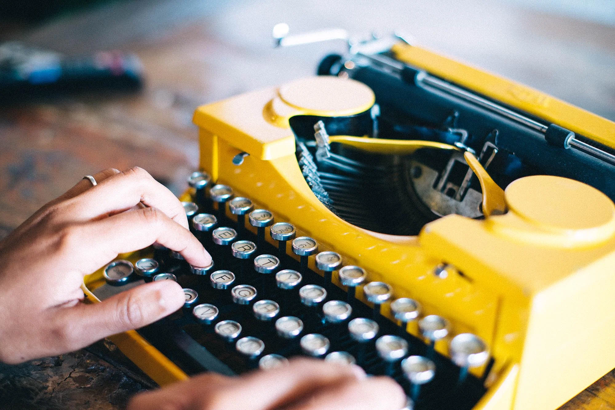 hands typing on vintage typewriter