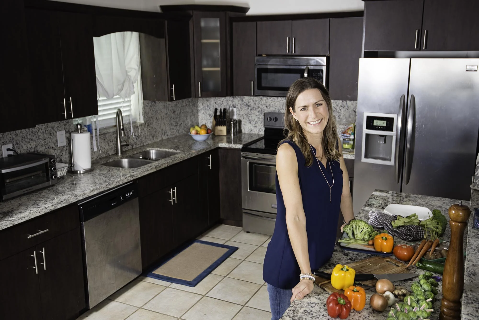 Woman With Vegetables in Kitchen
