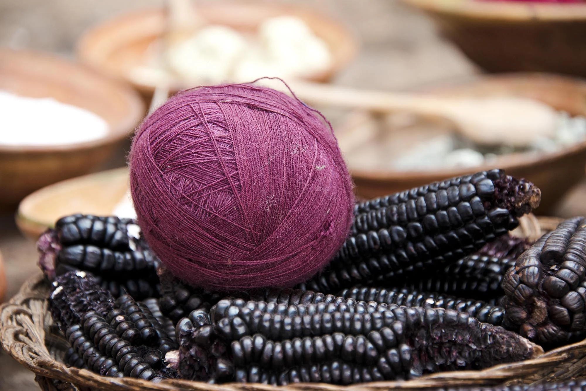 Fuschia Ball of Yarn on Top of Purple Corn