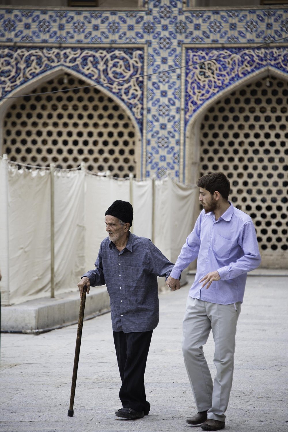 Young Man Walking With Old Man