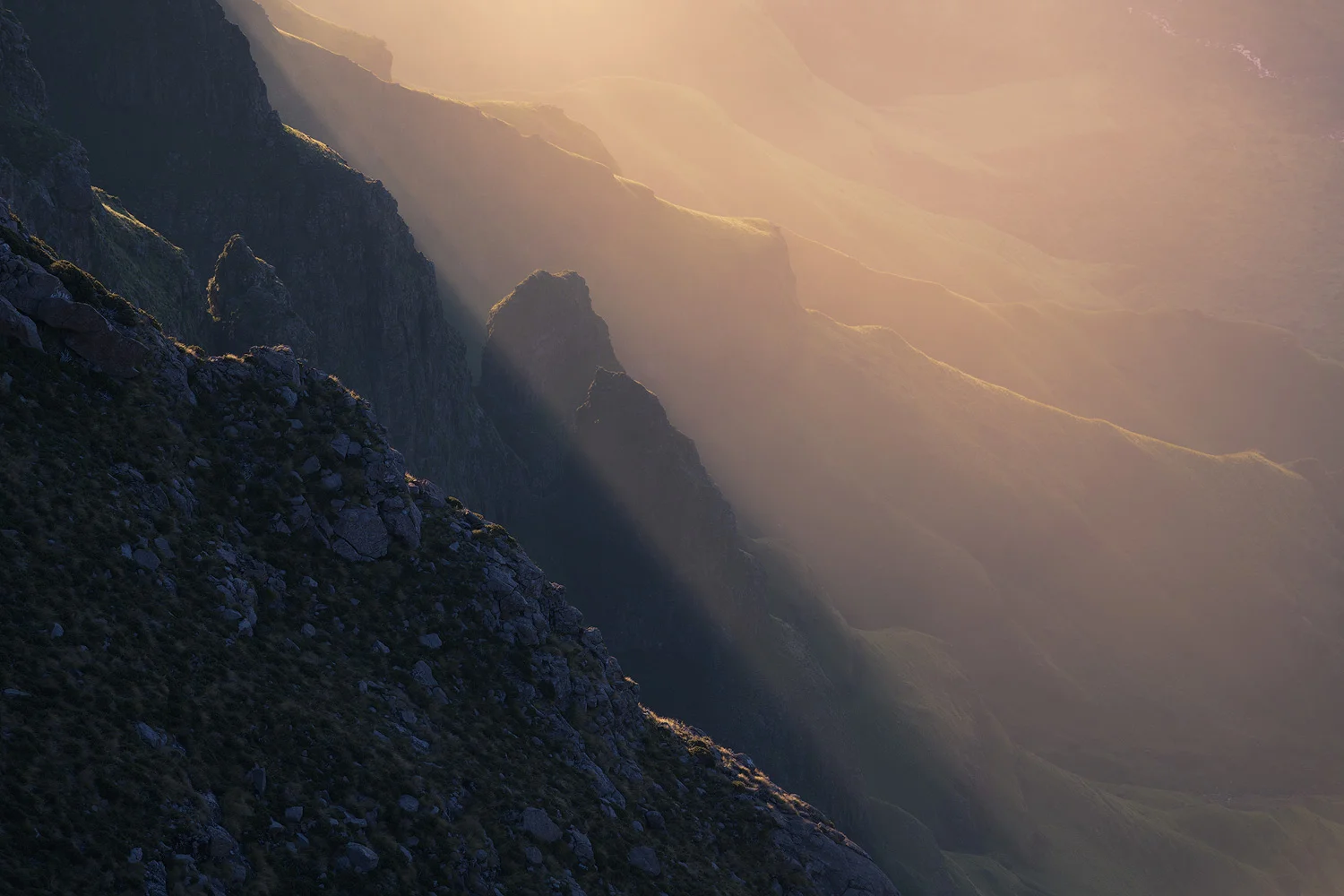 Nikon D850 / 70-200 f4 lens @ 200mm / ISO 200 - f/8 - 1/80 sec. The rays of light cutting through the valleys were beautiful, enhanced by the hazy air. I am not sure why I like this image, perhaps its the abstract representation and warm to cool colour contrast, and that shaft of light cutting the image in two.