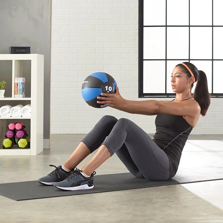 woman using medicine ball for home workout