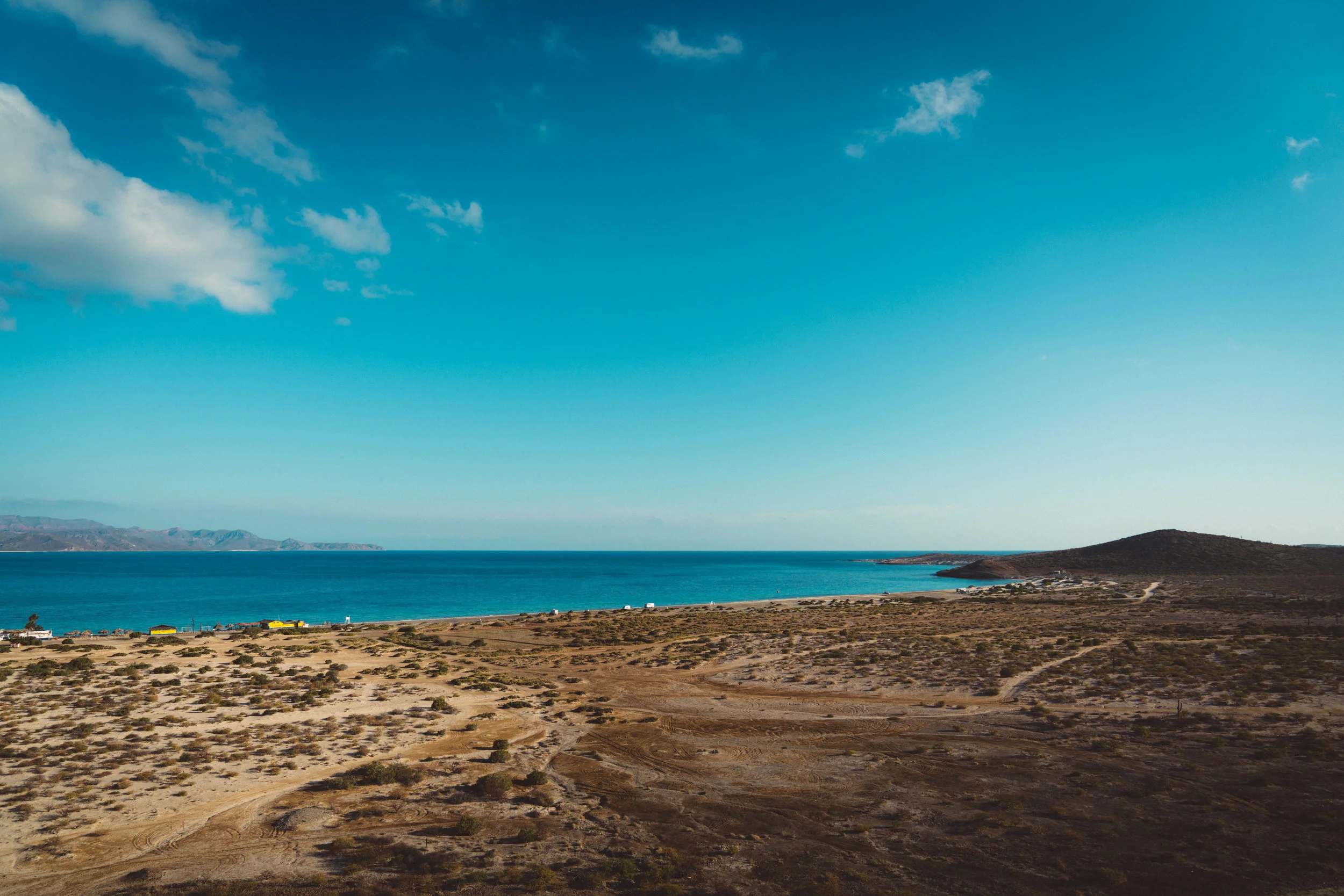 The same beach with the expanse of sand where we camped more visible. The rocks jutting out on the right side is where we found the coral reef and snorkeled.