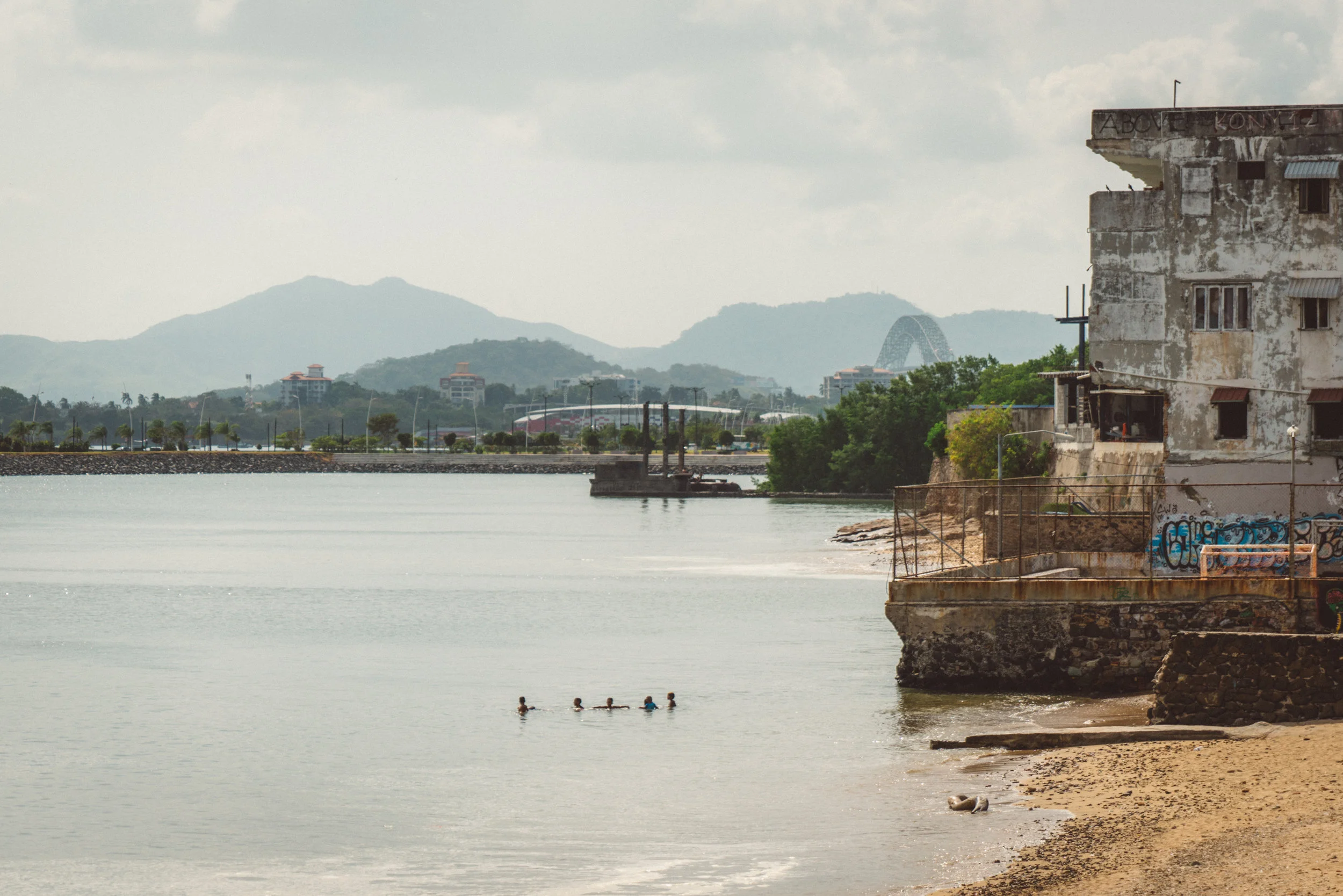 Some kids swimming off Casco Viejo. The Bridge of the Americas, which spans the Canal, is visible in the background.