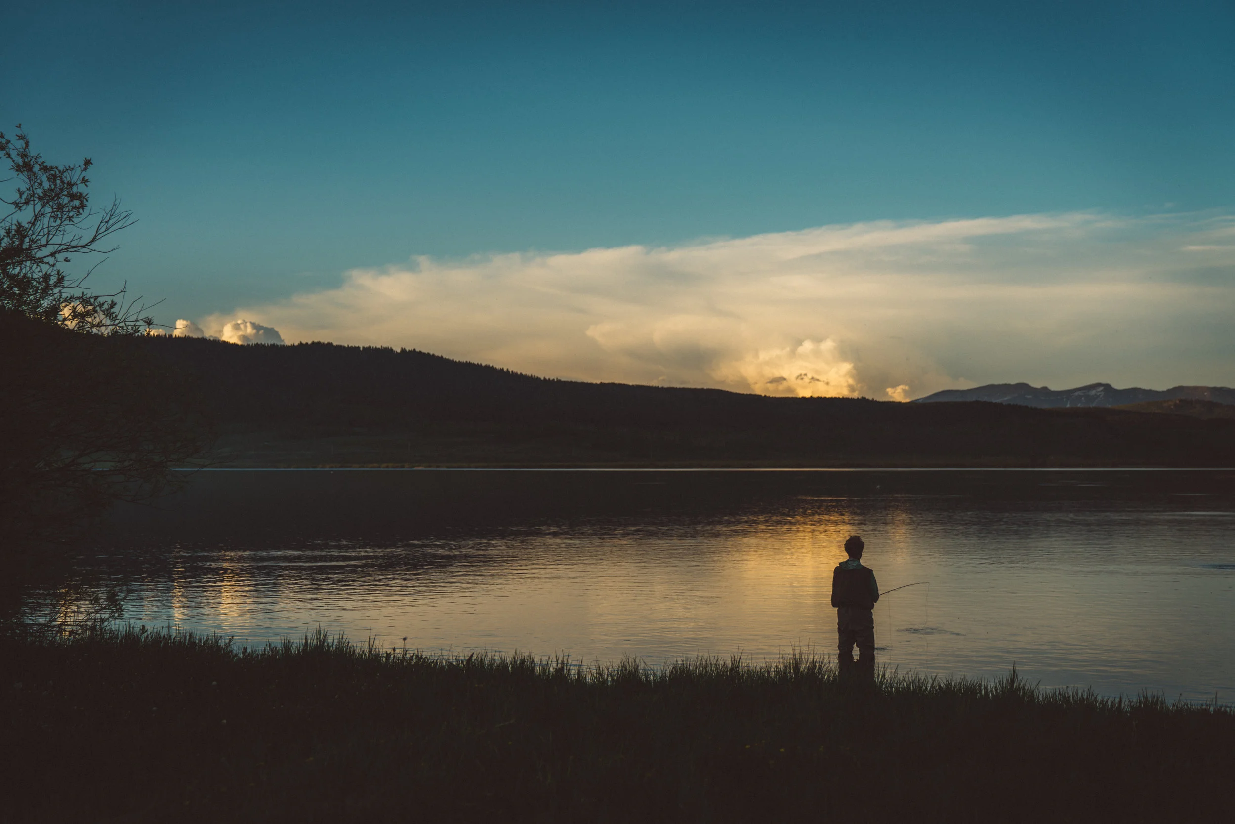 Returning to the lake at sunset, the same fisherman was still in the water to welcome me back.