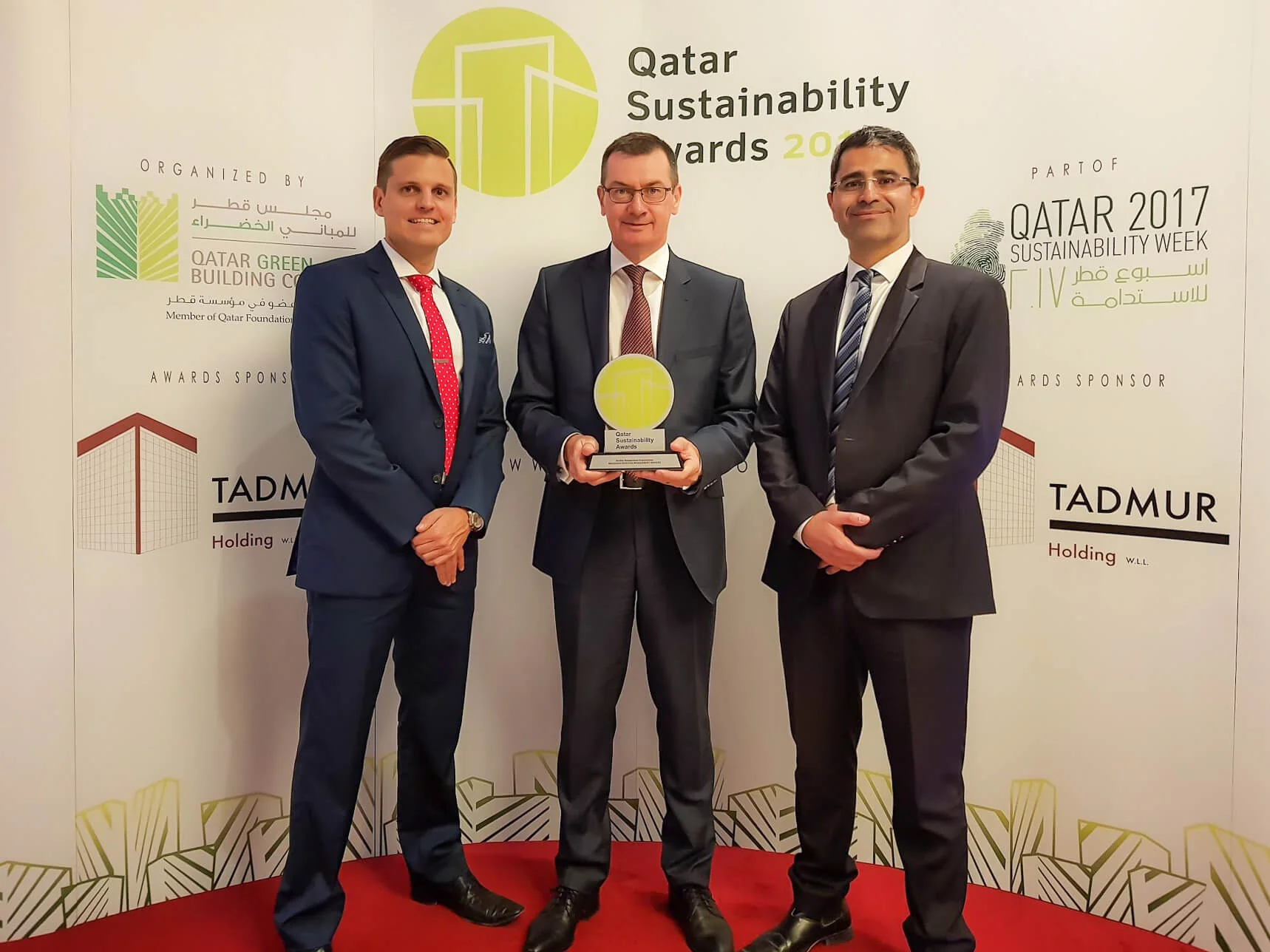 Left to Right: Adam Wood (Deputy Director), Martin Campbell (Director), Mustafa Adra (Project Director) with the award for Facility Management Organisation at the 2017 Qatar Sustainability Awards.