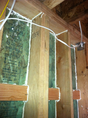 Step One: Seal the edges of each stud bay to reduce the range of convective air currents within the wall.