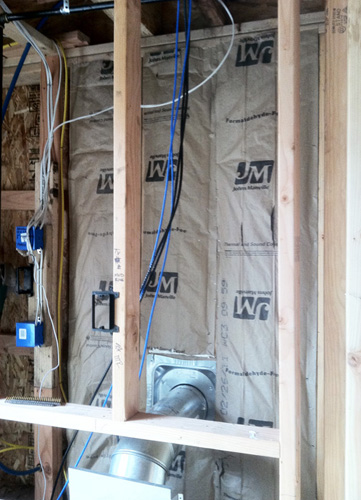 Step 2: Insulate with Formaldehyde Free Fiberglass Insulation. Staple craft paper facing tight to stud edges.