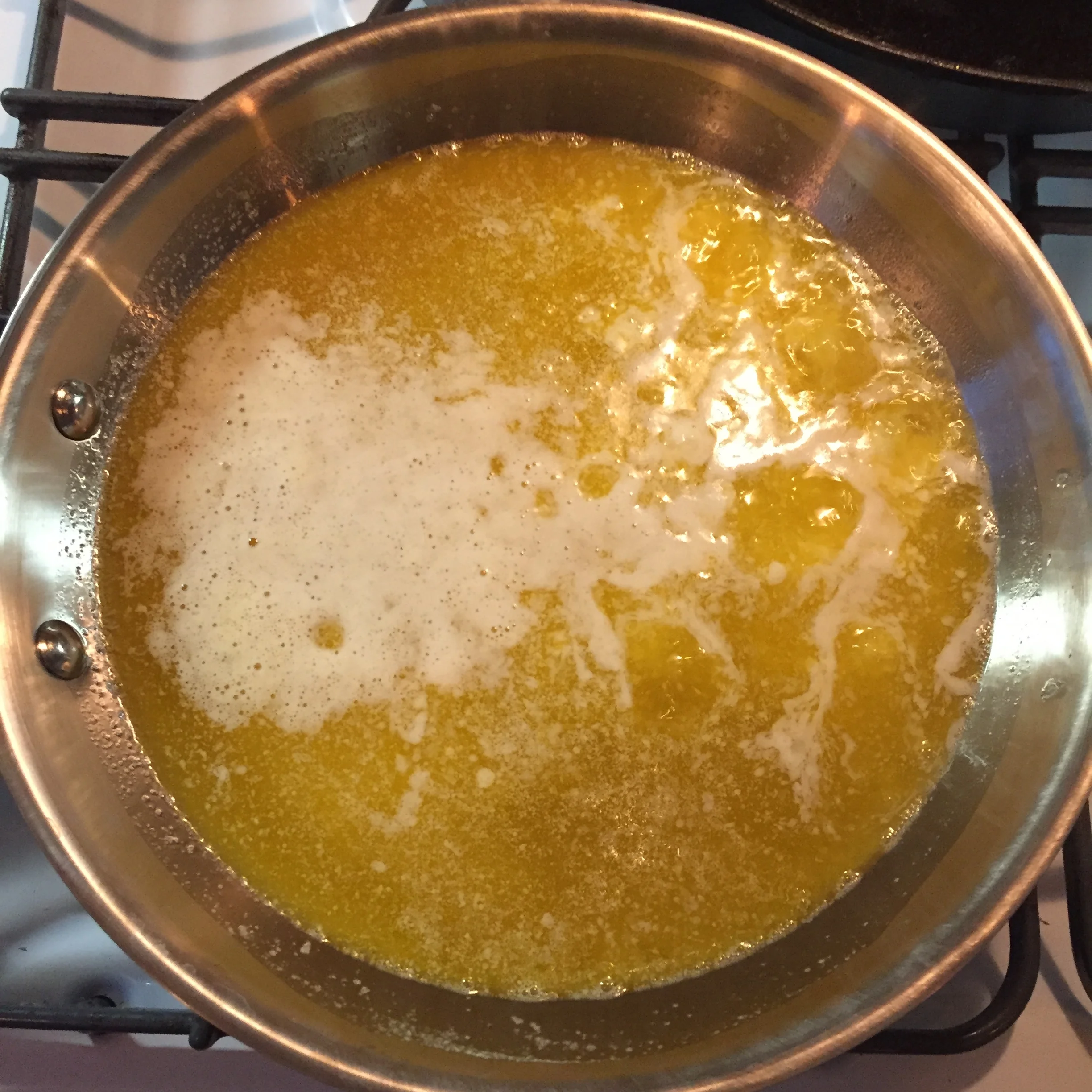 Cubes entirely melted, heat reduced to a low steady boil. First foam on top.