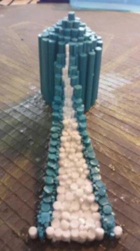 A week later, I had the first slope completed. This image shows both the sloping three dimensional view of the piece, as well as the different diameter rods employed. Each rod is individually cut to size and placed vertically onto the board using weld-bond cement.