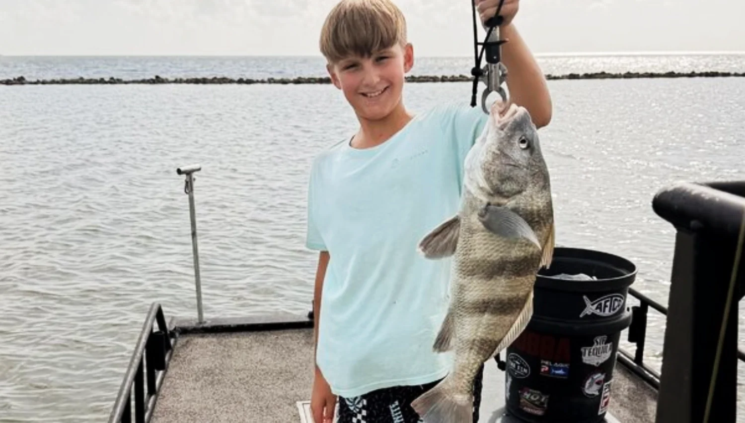 kid holding a fish catch
