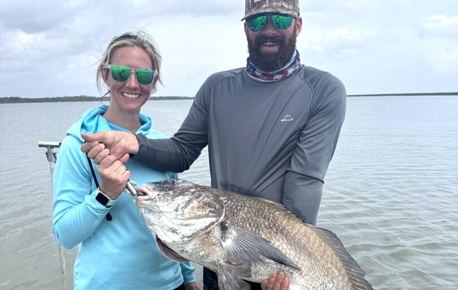 Texas Crew'd angler holding a large black drum on an April Rockport fishing trip