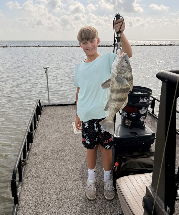 kid holding a fish catch