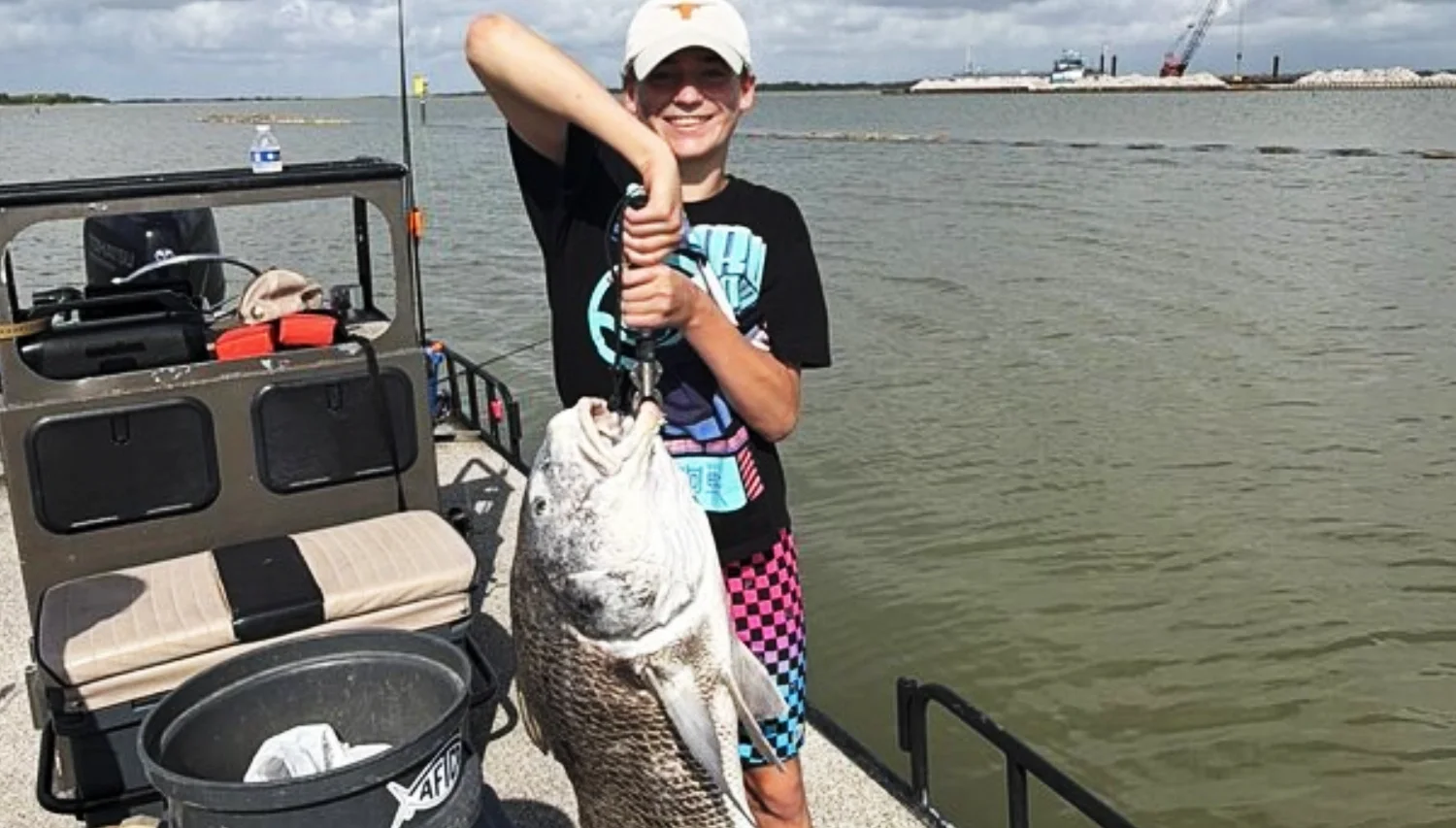 kid holding a huge fish