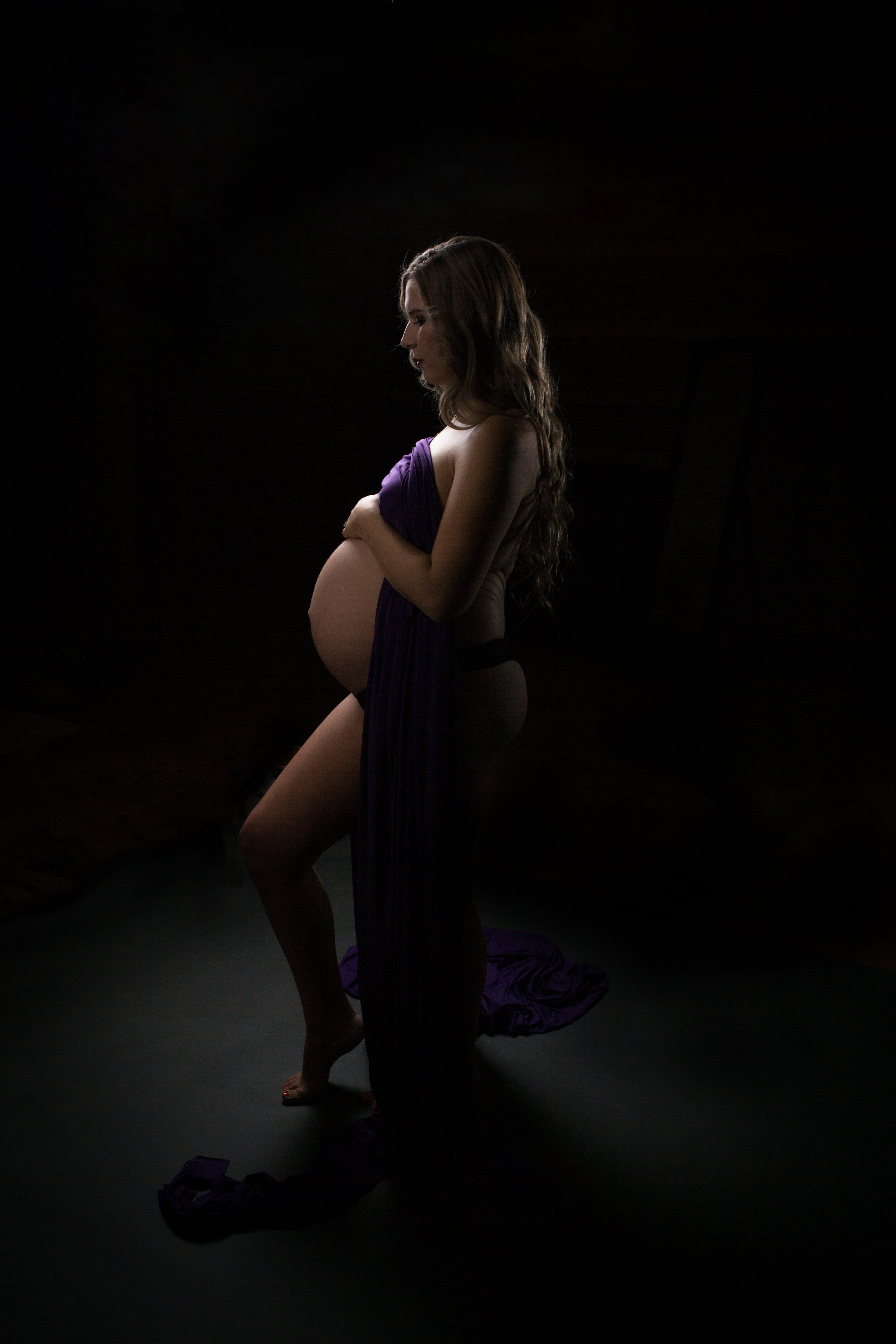 maternity boudoir silhouette glamour holding belly