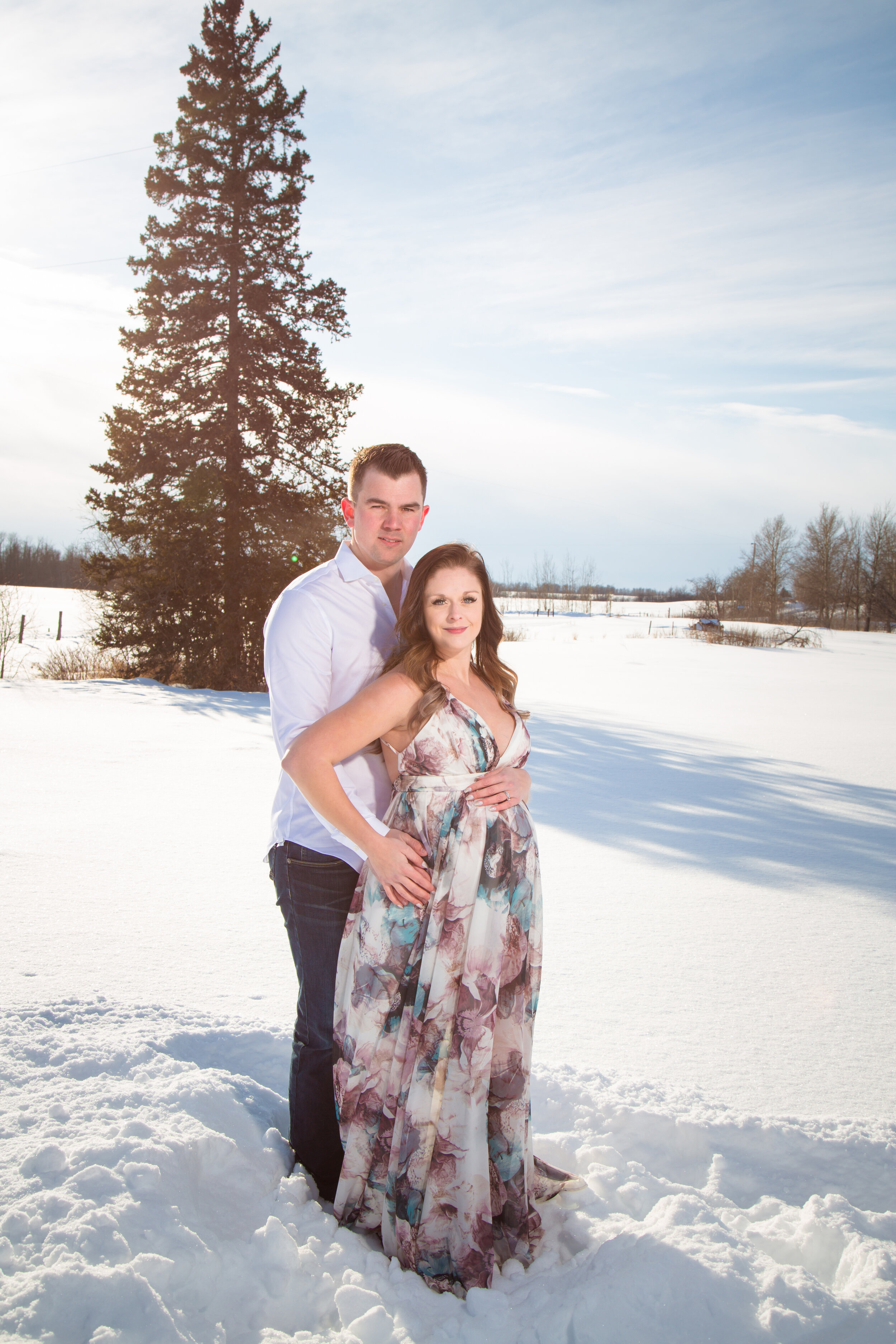happy winter couple maternity holding belly
