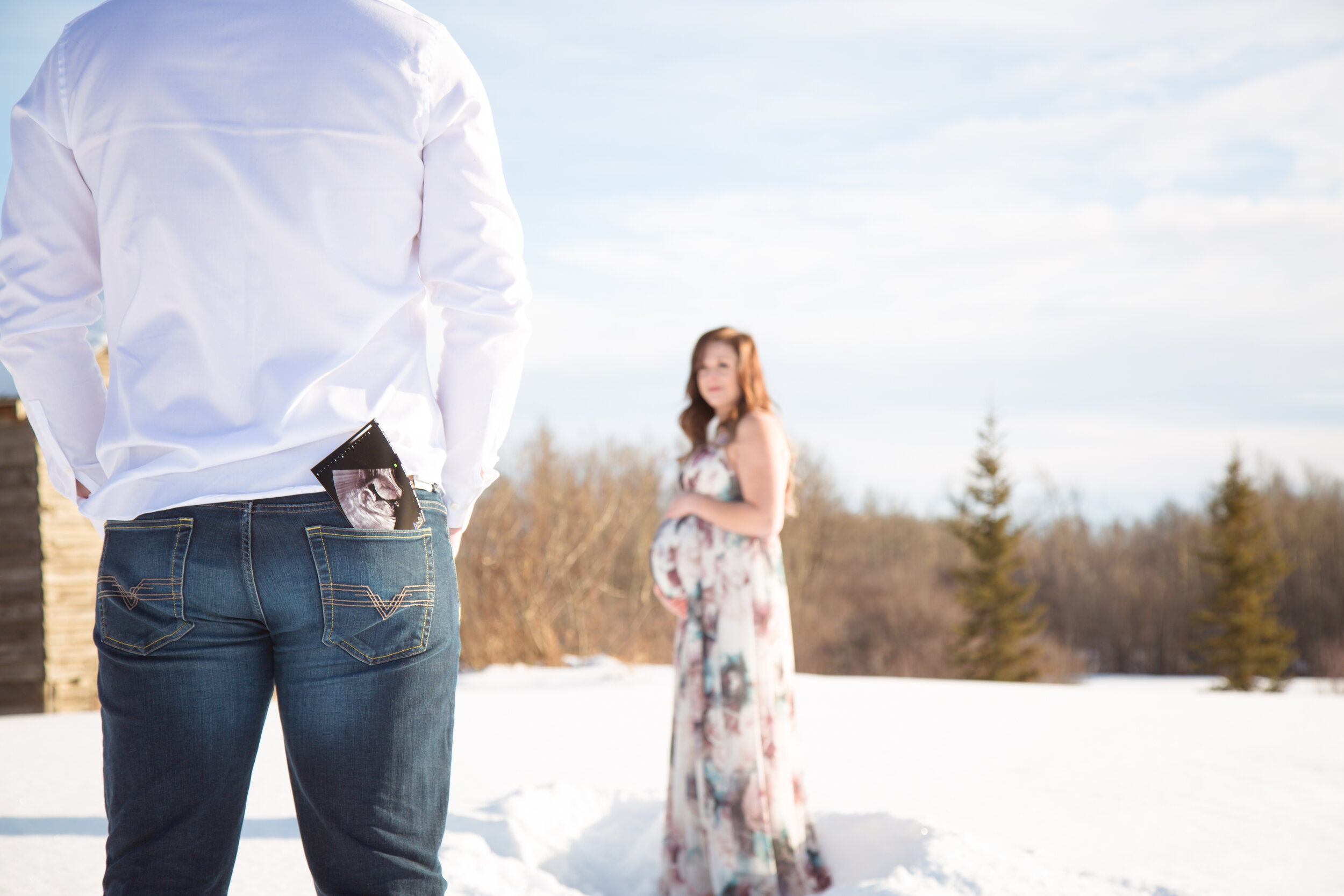  maternity reveal in the winter with photo in back pocket 