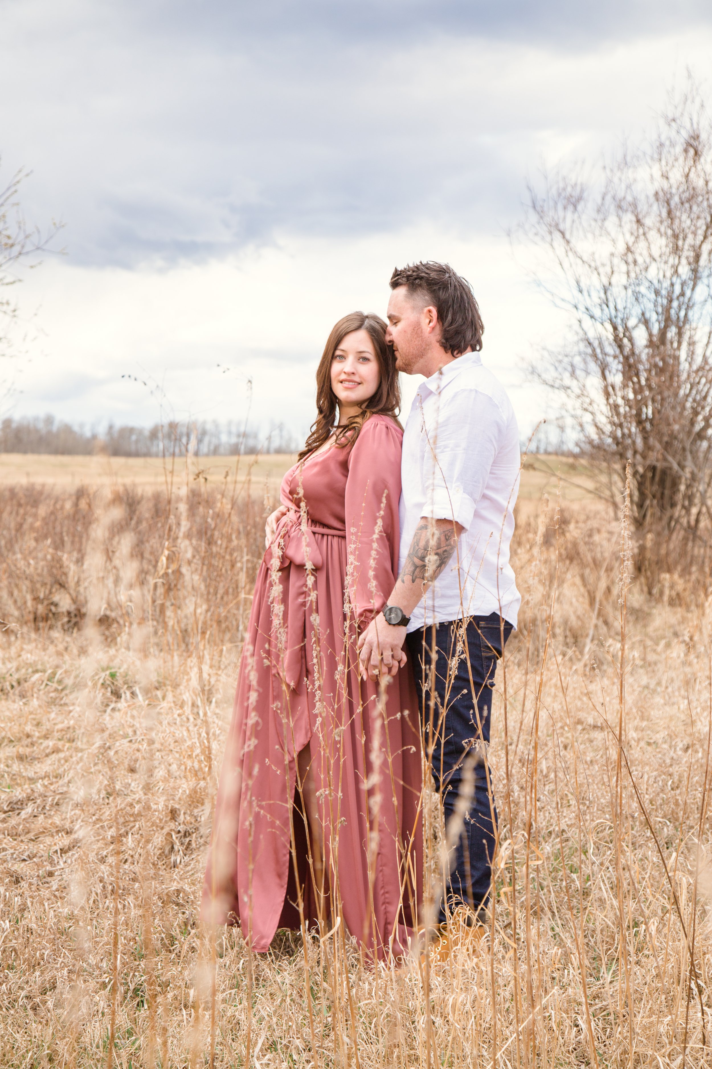  Grande Prairie Maternity Photoshoot couple in a fall field  