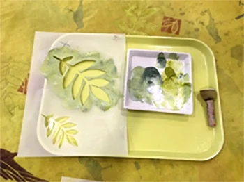 One of the stencils I used with a palette of paint and the stamping brush I prefer.