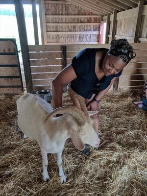 Michelle hanging with a rescued goat at the famous “Farm Sanctuary” in Watkins Glen, NY.